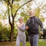 Smiling,Senior,Couple,Jogging,In,The,Park.,Sports,Activities,For