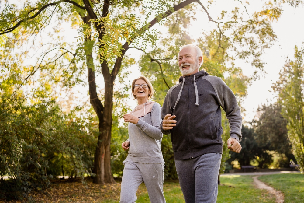 Smiling,Senior,Couple,Jogging,In,The,Park.,Sports,Activities,For